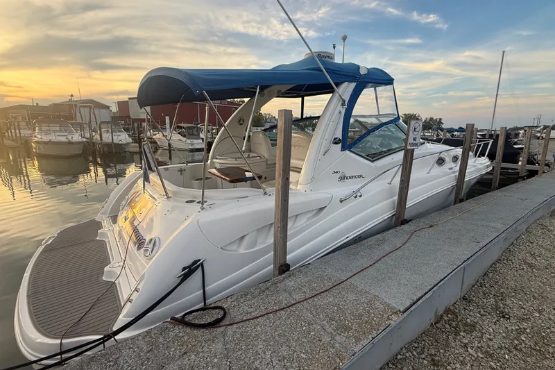 The Image of 2007 Sea Ray 340 Sundancer docked at marina during sunset. - 2