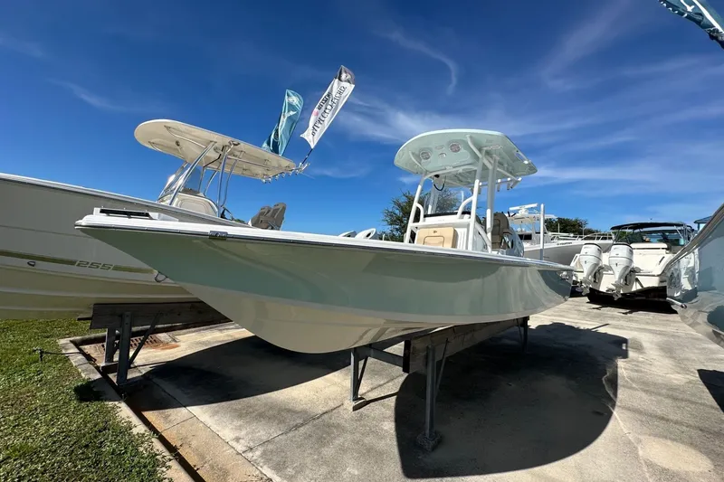 Slide: The Image of 2026 Sea Pro 230 Bay boat displayed outdoors under a clear blue sky. - 1