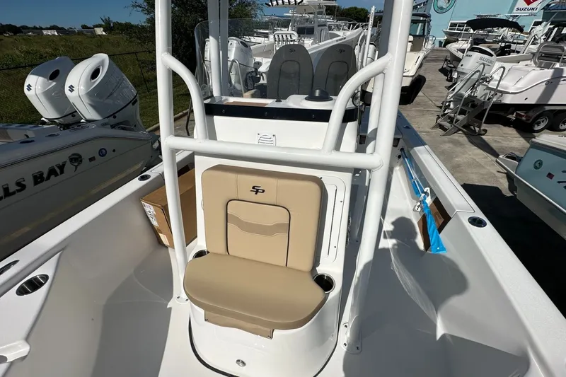 Slide: The Image of 2026 Sea Pro 230 Bay boat interior with beige seating and dual engines. - 9
