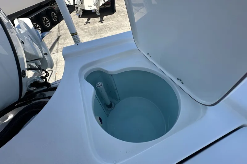 Slide: The Image of Open livewell on 2026 Sea Pro 230 Bay boat, showcasing interior design and functionality. - 14
