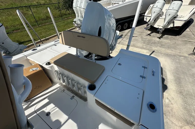 Slide: The Image of 2026 Sea Pro 230 Bay boat interior with seating and storage compartments. - 11