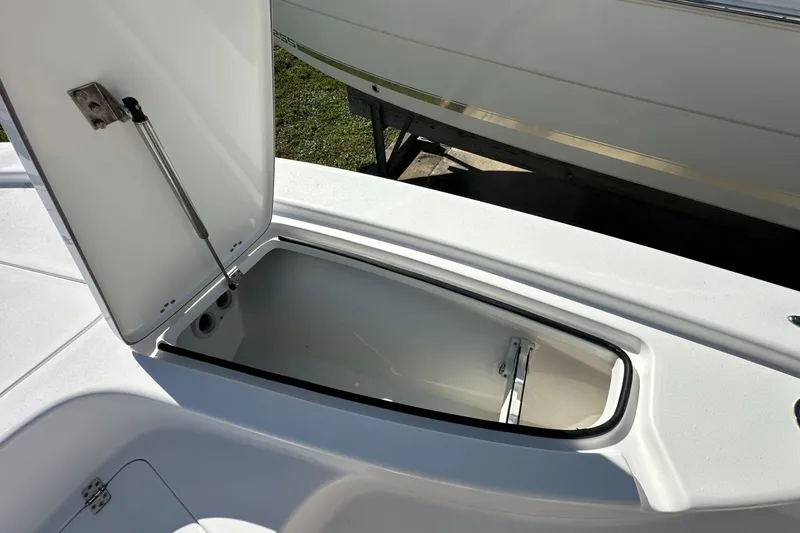 Slide: The Image of Open storage compartment on 2026 Sea Pro 230 Bay boat deck. - 7