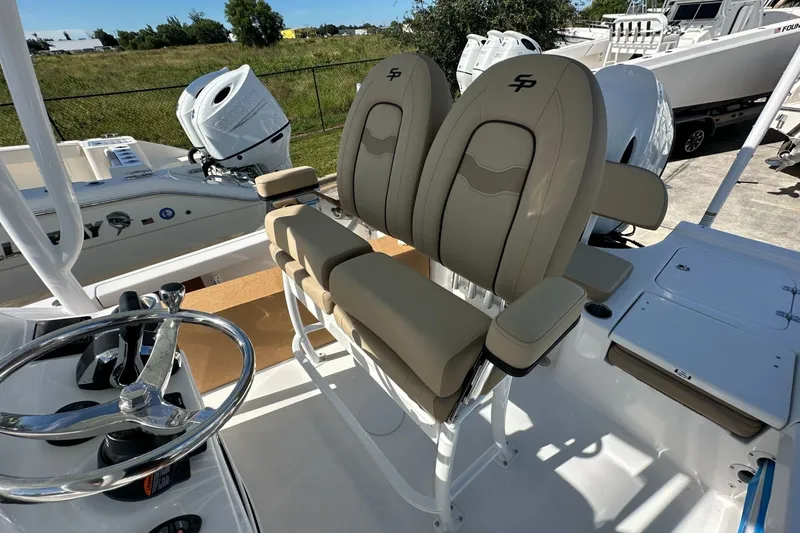 Slide: The Image of 2026 Sea Pro 230 Bay boat interior with dual seats and steering wheel. - 10