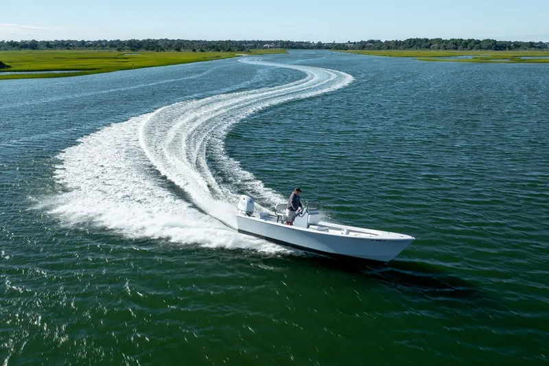 Slide: The Image of 1980 Sea Ox 230 Center Console boat cruising on a scenic waterway. - 14