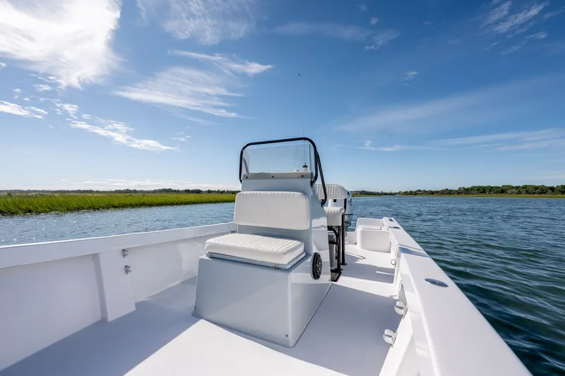 Slide: The Image of 1980 Sea Ox 230 Center Console boat on calm water under clear blue sky. - 16