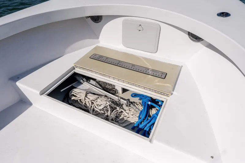 Slide: The Image of Storage compartment on a 1980 Sea Ox 230 Center Console boat with ropes and netting. - 29
