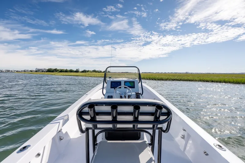Slide: The Image of 1980 Sea Ox 230 Center Console boat on calm water under a clear blue sky. - 17