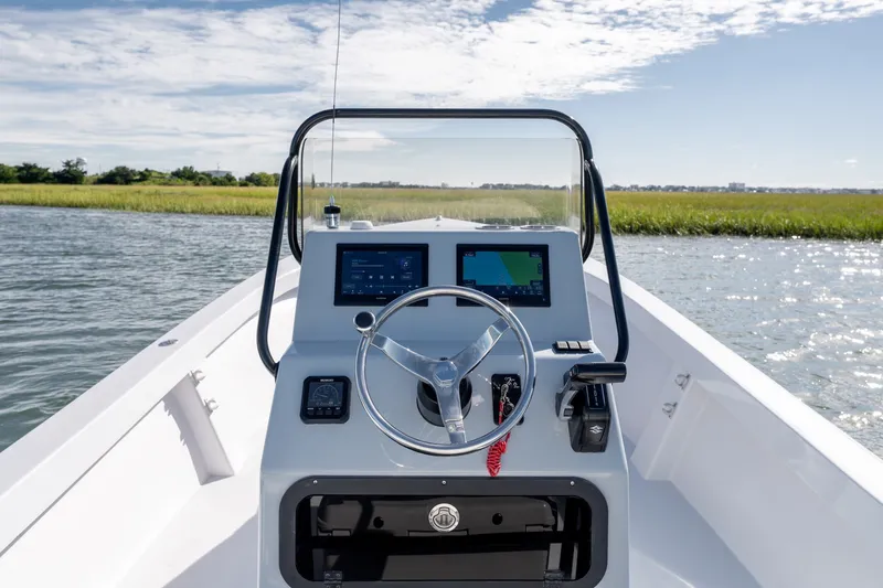 Slide: The Image of 1980 Sea Ox 230 Center Console boat on water, featuring modern navigation equipment. - 18