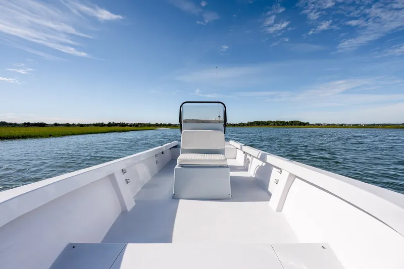 Slide: The Image of 1980 Sea Ox 230 Center Console boat on calm water under blue sky. - 24