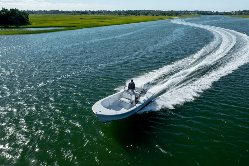 Slide: The Image of 1980 Sea Ox 230 Center Console boat cruising on a scenic waterway. - 13