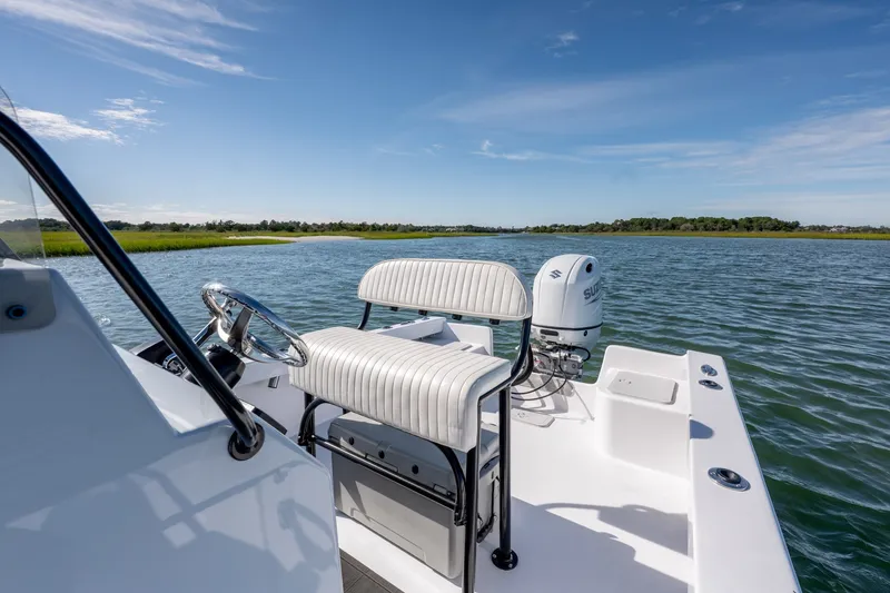 Slide: The Image of 1980 Sea Ox 230 Center Console boat on calm water, featuring a white seating area. - 21