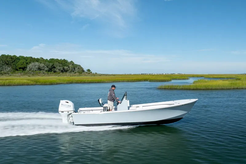 The Image of 1980 Sea Ox 230 Center Console boat cruising on a scenic waterway. - 0