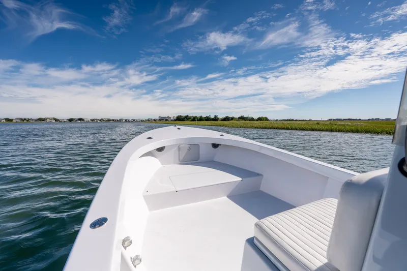 Slide: The Image of 1980 Sea Ox 230 Center Console boat on calm water under a clear blue sky. - 22