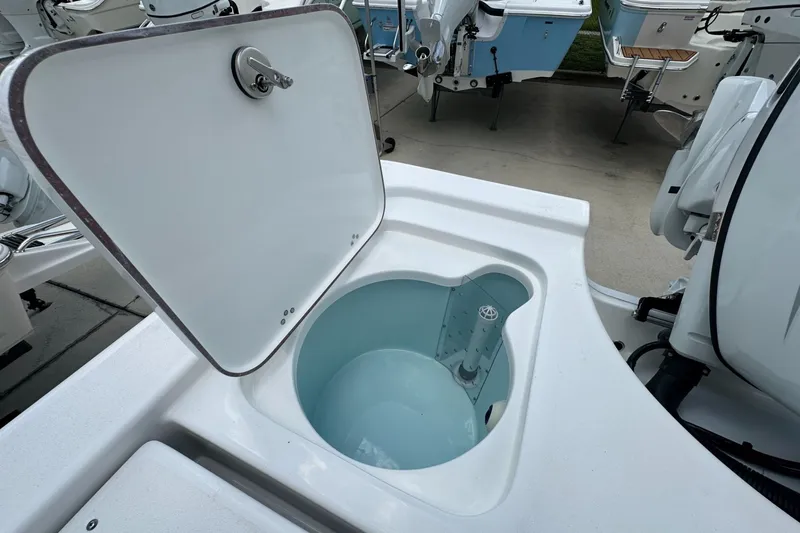 Slide: The Image of Open hatch on 2026 Sea Pro 230 Bay boat, revealing storage compartment. - 16