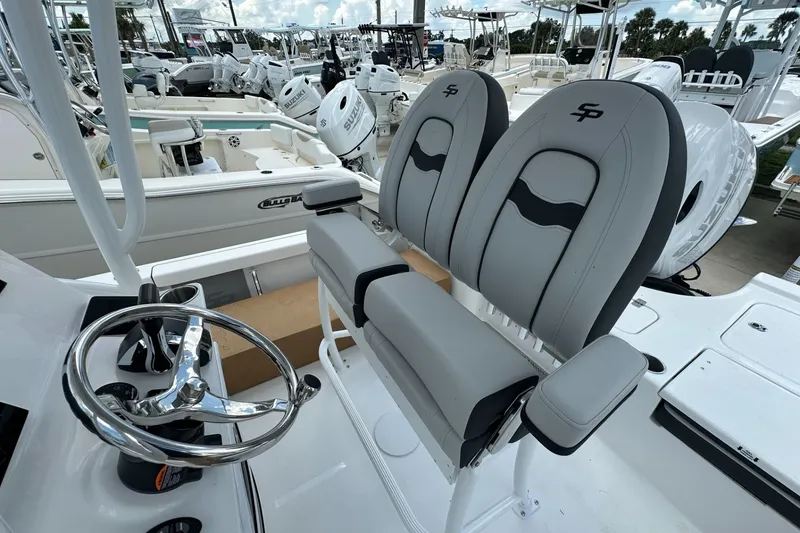 Slide: The Image of 2026 Sea Pro 230 Bay boat interior with dual seats and steering wheel. - 13