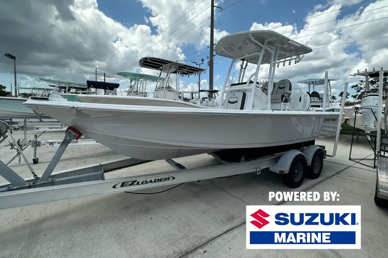 The Image of 2026 Sea Pro 230 Bay boat on trailer, powered by Suzuki Marine, under cloudy sky. - 0