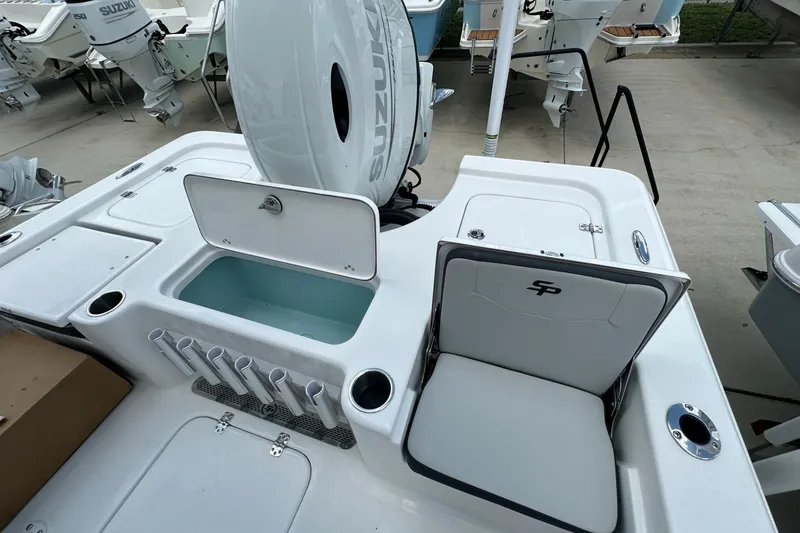 Slide: The Image of 2026 Sea Pro 230 Bay boat interior with Suzuki engine, featuring seating and storage compartments. - 14