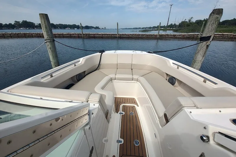 Slide: The Image of 2018 Boston Whaler 320 Vantage boat interior with cushioned seating and wood flooring. - 54