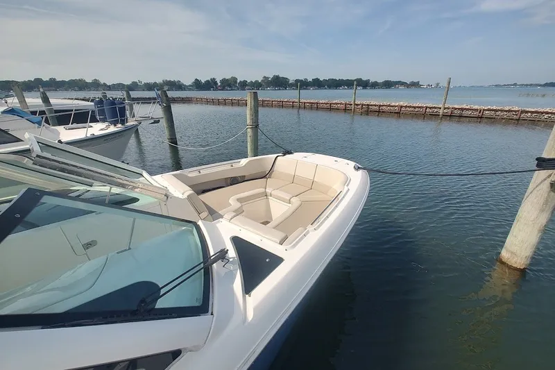 Slide: The Image of 2018 Boston Whaler 320 Vantage docked, showcasing sleek design and spacious seating. - 53