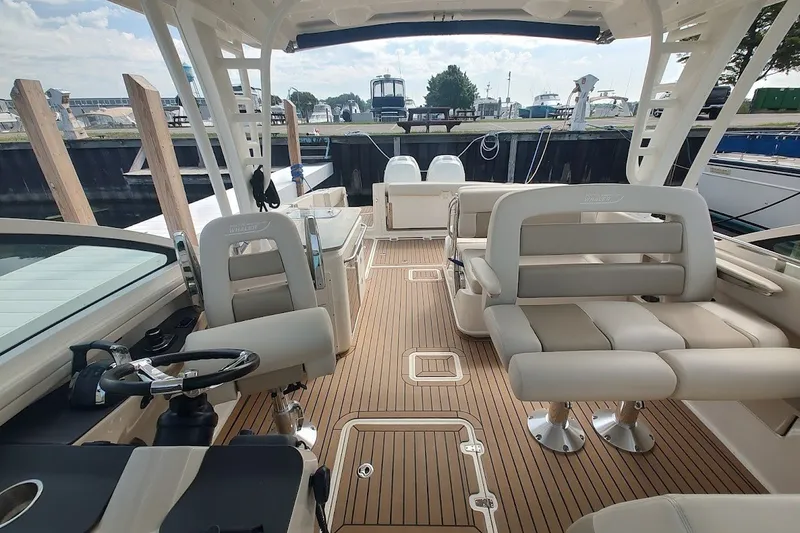 Slide: The Image of 2018 Boston Whaler 320 Vantage boat interior with seating and steering wheel. - 57