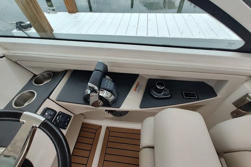 Slide: The Image of 2018 Boston Whaler 320 Vantage helm with controls and cup holders. - 51