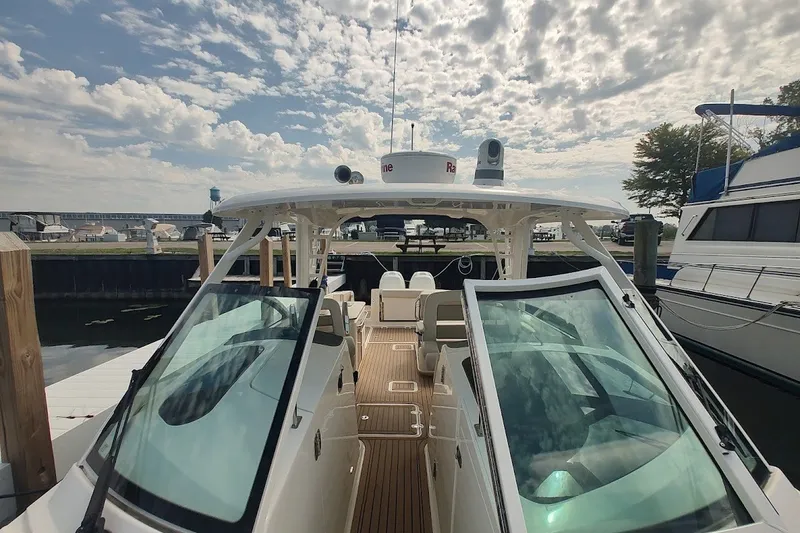 Slide: The Image of 2018 Boston Whaler 320 Vantage docked, showcasing sleek design and spacious deck. - 55