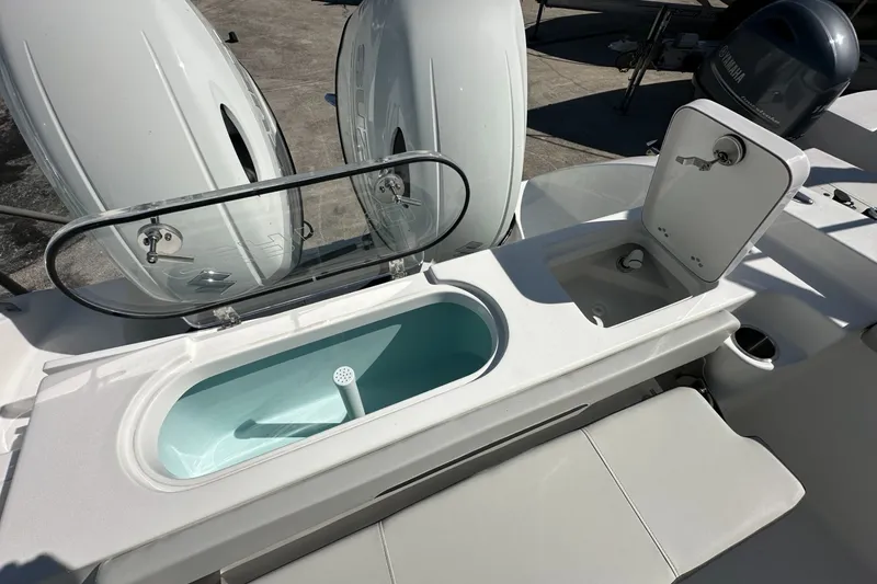 Slide: The Image of 2026 Sea Pro 262 Offshore boat with livewell and storage compartments. - 12