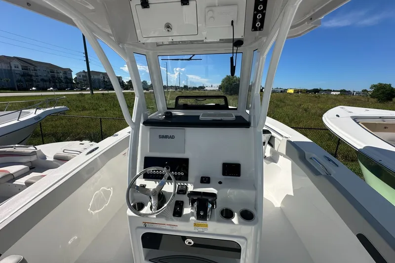 Slide: The Image of 2026 Sea Pro 262 Offshore boat cockpit with steering wheel and control panel. - 3