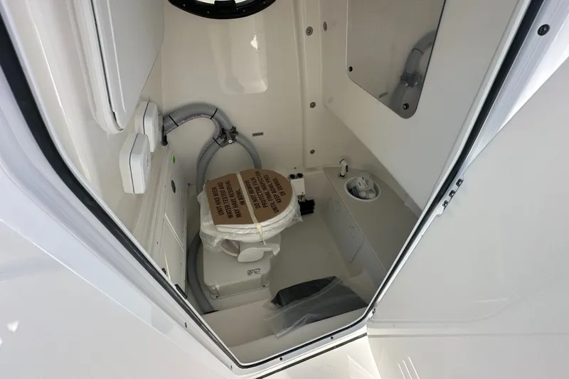 Slide: The Image of 2026 Sea Pro 262 Offshore boat interior with compact marine toilet. - 8