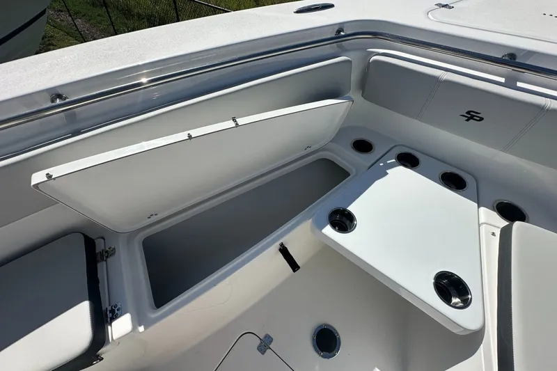 Slide: The Image of 2026 Sea Pro 262 Offshore boat interior with storage compartments and cup holders. - 6