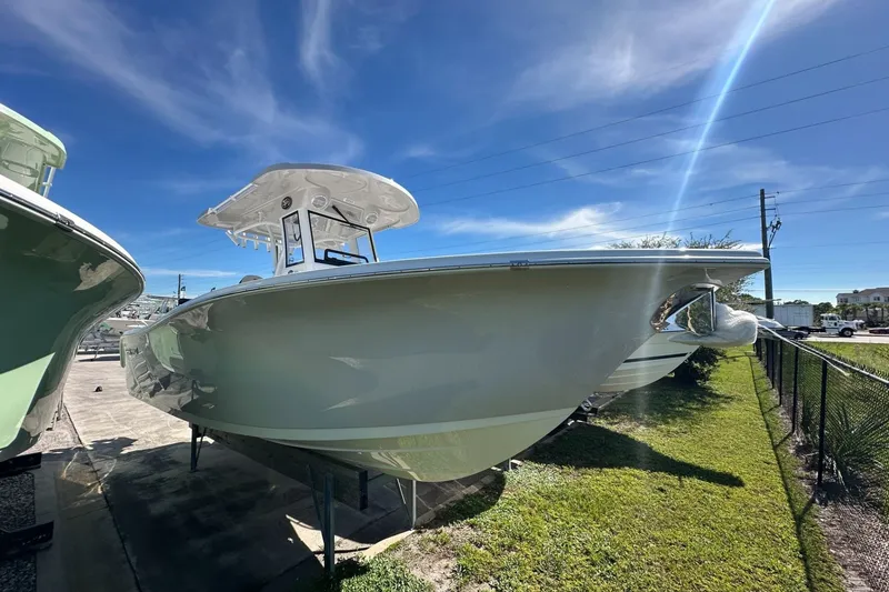 Slide: The Image of 2026 Sea Pro 262 Offshore boat displayed outdoors under a clear blue sky. - 1