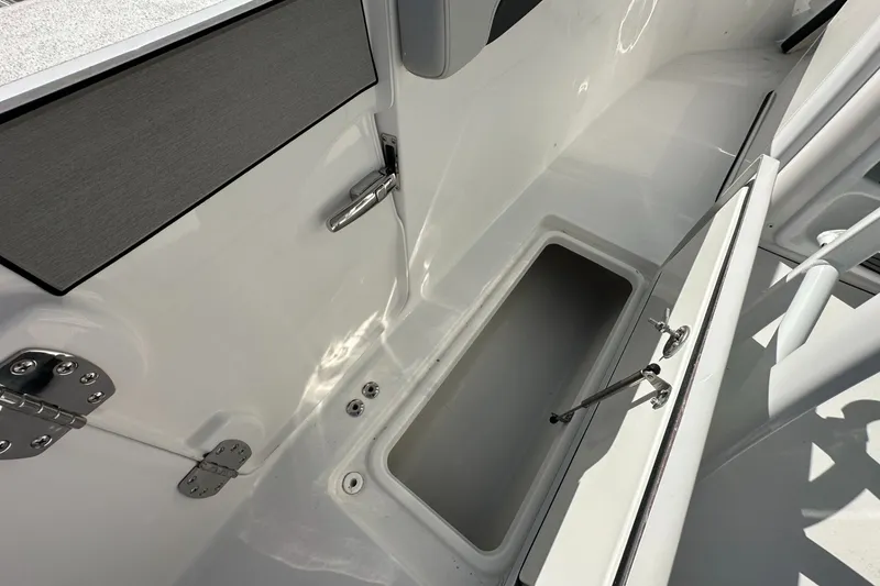 Slide: The Image of 2026 Sea Pro 262 Offshore boat storage compartment with open hatch and stainless steel hardware. - 13