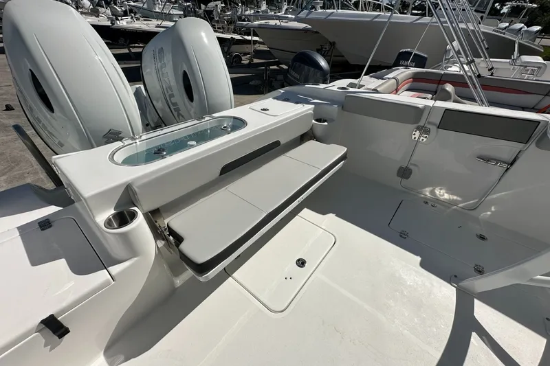 Slide: The Image of 2026 Sea Pro 262 Offshore boat interior with seating and dual Suzuki engines. - 11