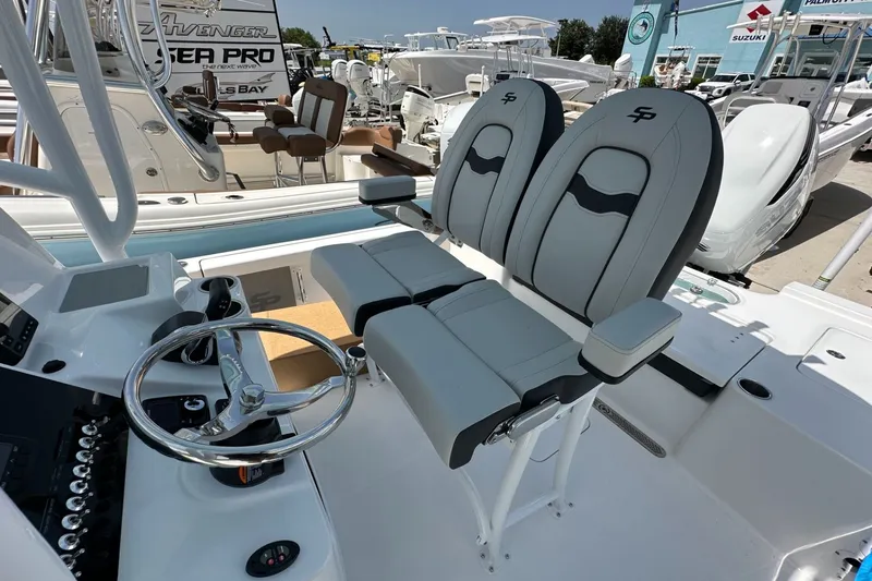 Slide: The Image of 2026 Sea Pro 250 Bay boat interior with dual seats and steering wheel. - 9