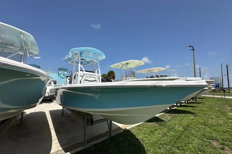 Slide: The Image of 2026 Sea Pro 250 Bay boat displayed outdoors under clear blue sky. - 1
