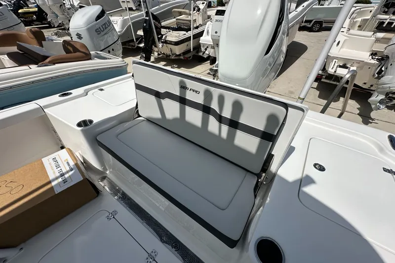 Slide: The Image of 2026 Sea Pro 250 Bay boat interior with seating and storage compartments. - 11