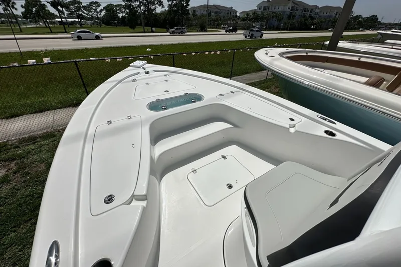 Slide: The Image of 2026 Sea Pro 250 Bay boat deck with seating and storage compartments. - 4