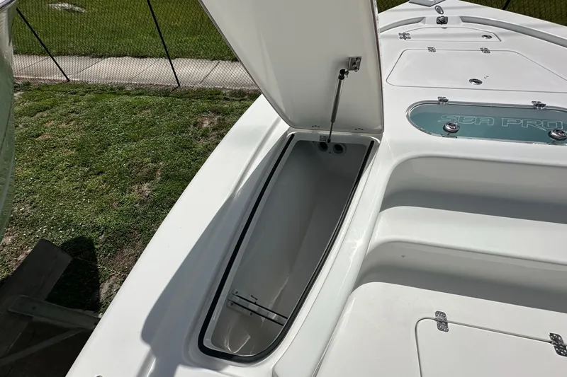 Slide: The Image of 2026 Sea Pro 250 Bay boat with open storage compartment on deck. - 5