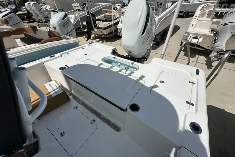 Slide: The Image of 2026 Sea Pro 250 Bay boat deck with Suzuki outboard motor in a marina. - 10