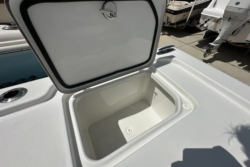 Slide: The Image of Open storage compartment on 2026 Sea Pro 250 Bay boat deck. - 14