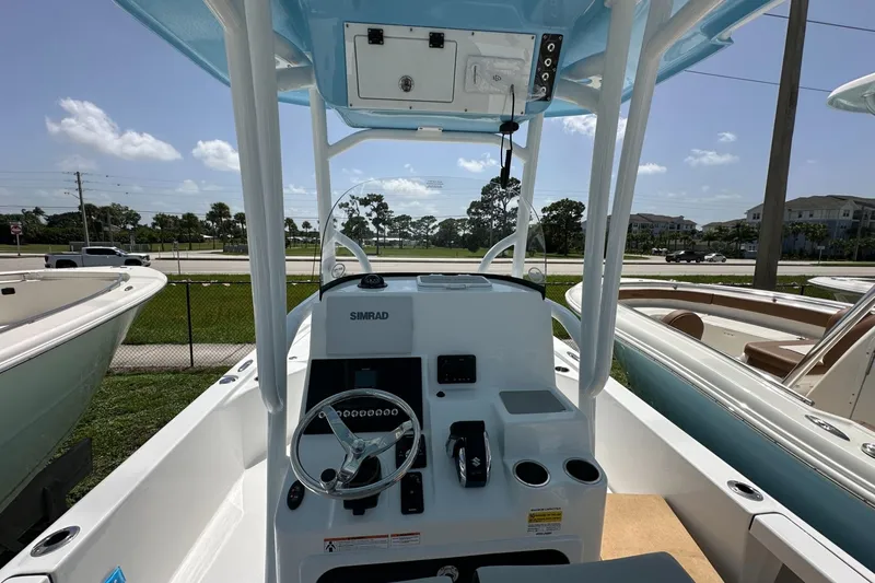 Slide: The Image of 2026 Sea Pro 250 Bay boat interior with steering wheel and control panel. - 3