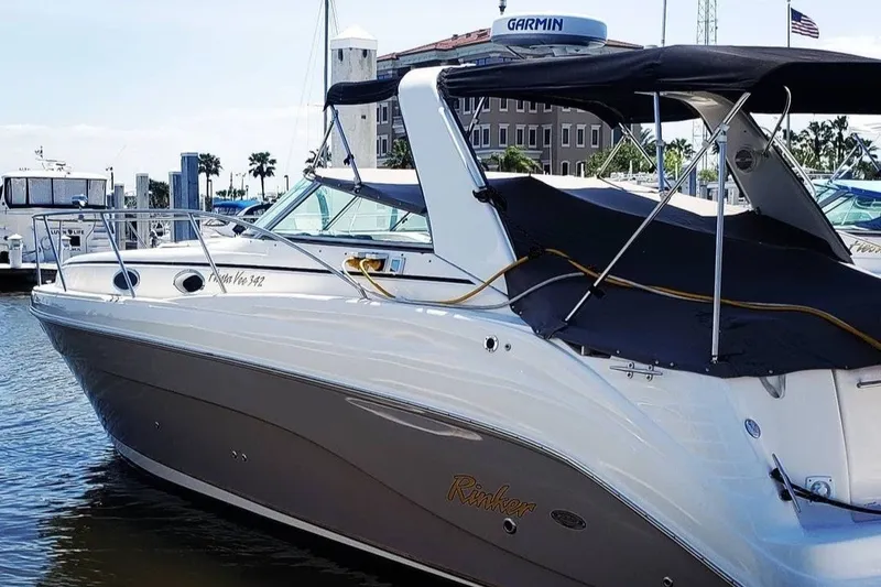 Slide: The Image of 2006 Rinker Fiesta Vee 342 boat docked at marina, featuring sleek design and Garmin equipment. - 0