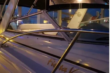 Slide: The Image of 2006 Rinker Fiesta Vee 342 boat at night, featuring sleek design and illuminated interior. - 3