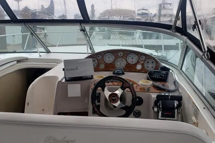 Slide: The Image of 2006 Rinker Fiesta Vee 342 boat cockpit with steering wheel and navigation instruments. - 6