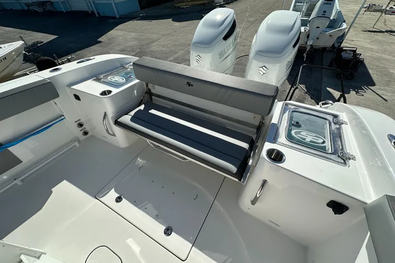 Slide: The Image of 2026 Sea Pro 292 DLX boat interior with seating and dual outboard engines. - 17
