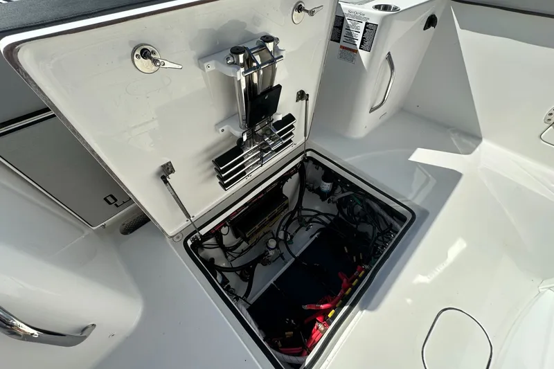 Slide: The Image of Open hatch of 2026 Sea Pro 292 DLX boat showing internal wiring and components. - 20