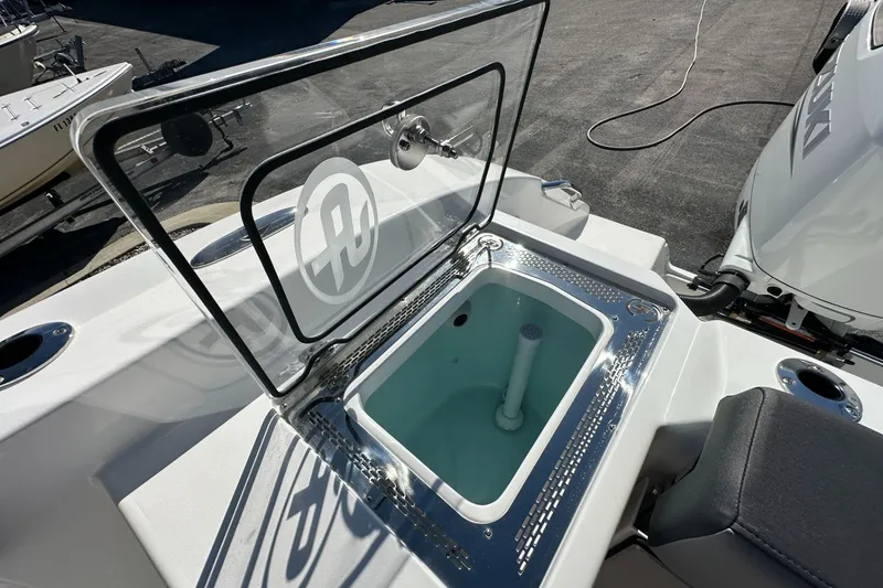Slide: The Image of Livewell on 2026 Sea Pro 292 DLX boat, featuring a transparent lid and sleek design. - 19
