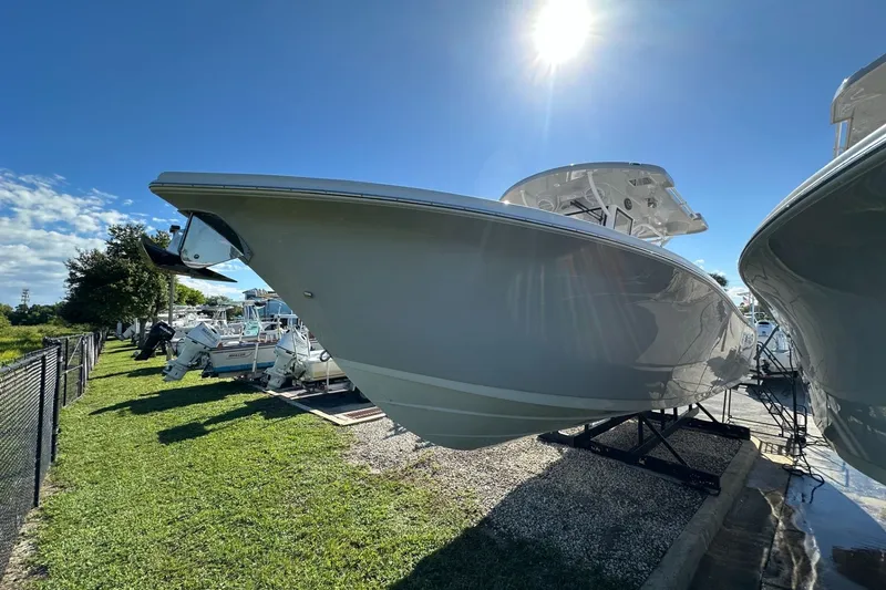 Slide: The Image of 2026 Sea Pro 292 DLX boat displayed outdoors under bright sunlight. - 1