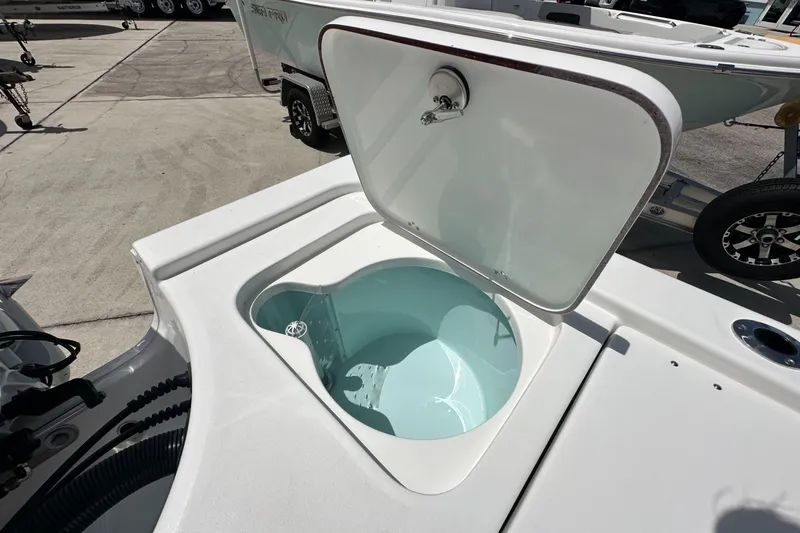 Slide: The Image of Open storage compartment on a 2026 Sea Pro 230 Bay boat, showcasing interior design. - 16