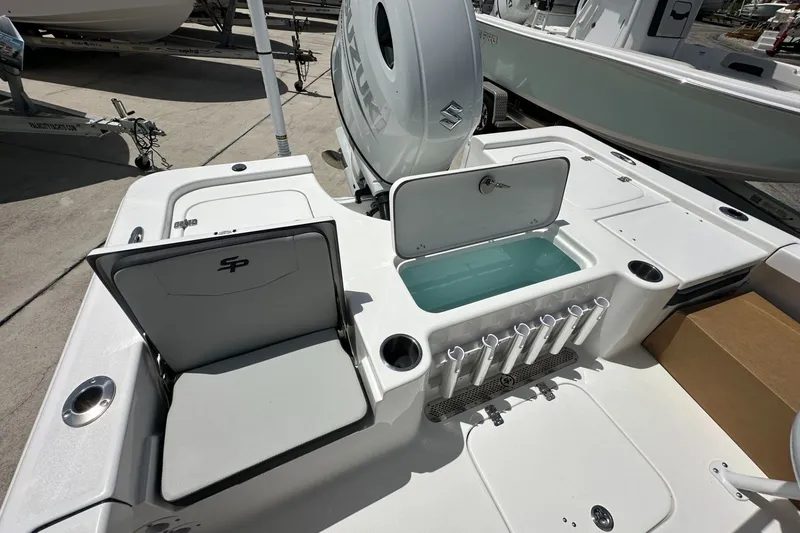 Slide: The Image of 2026 Sea Pro 230 Bay boat interior with seating, storage, and rod holders. - 14